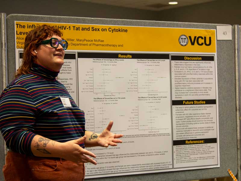 Pharm.D. student Alice Adkins presents her research to a classmate capturing her on camera during Research Day.