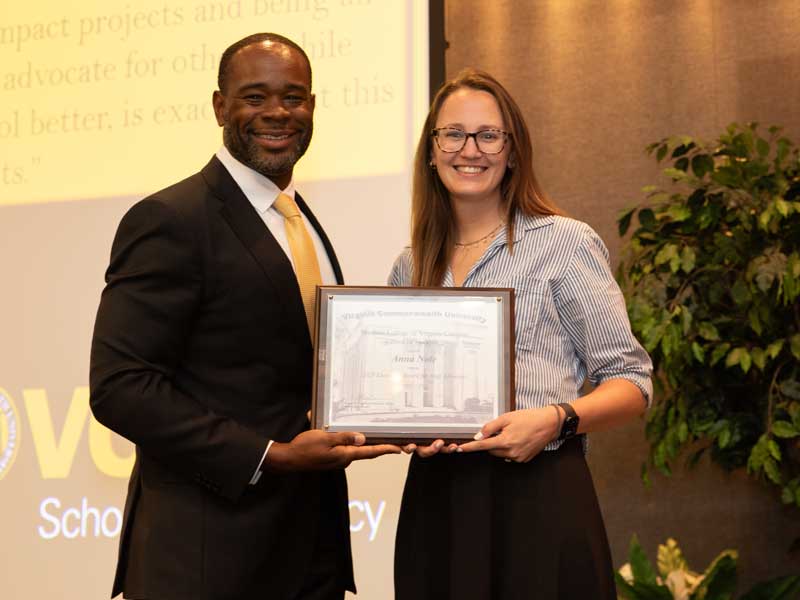 Standing next to Dean K.C. Ogbonna, Anna Nole accepts the Executive Award for Staff Advocacy