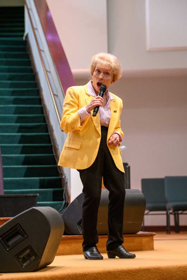 Donna Clevinger, Ph.D., a Mississippi State University professor of communication and theatre and a former administrator dressed in VCU black and gold, catches the camera while looking surprised as she tells the audience the story of the life and legacy of her father, Lawrence Earle Clevinger, for whom the Preceptor of the Year Award was named this year.