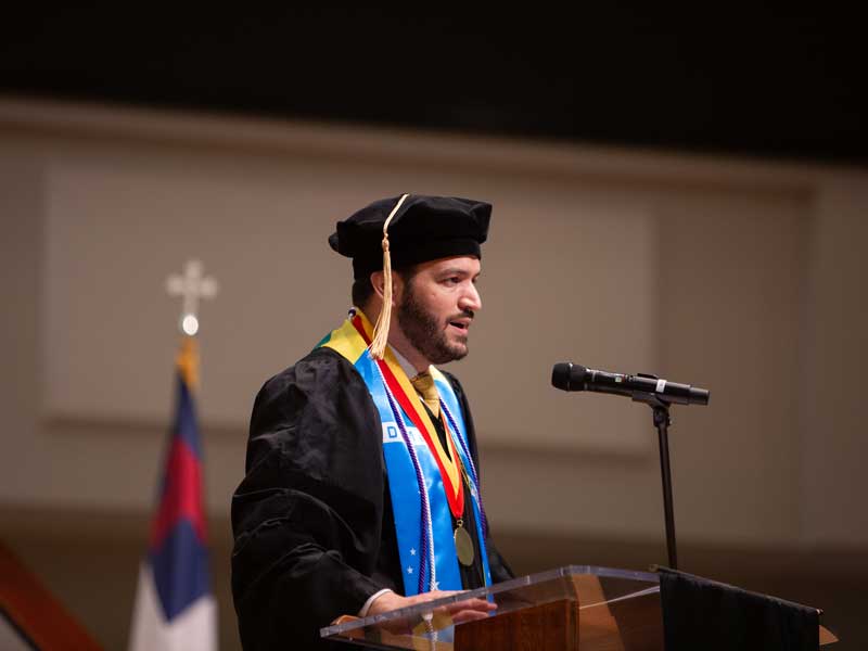 Graduate student speaker Silas Contaifer, Ph.D., shares his hopes for the Class of 2025 at the VCU School of Pharmacy Hooding and Diploma Ceremony on May 9, 2025, at St. Paul’s Baptist Church North.