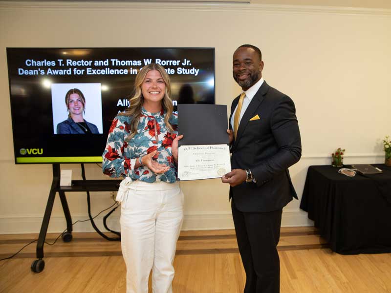 Ally Thompson joins Dean K.C. Ogbonna to receive the Dean's Awards at the 2026 Graduate Awards Ceremony.