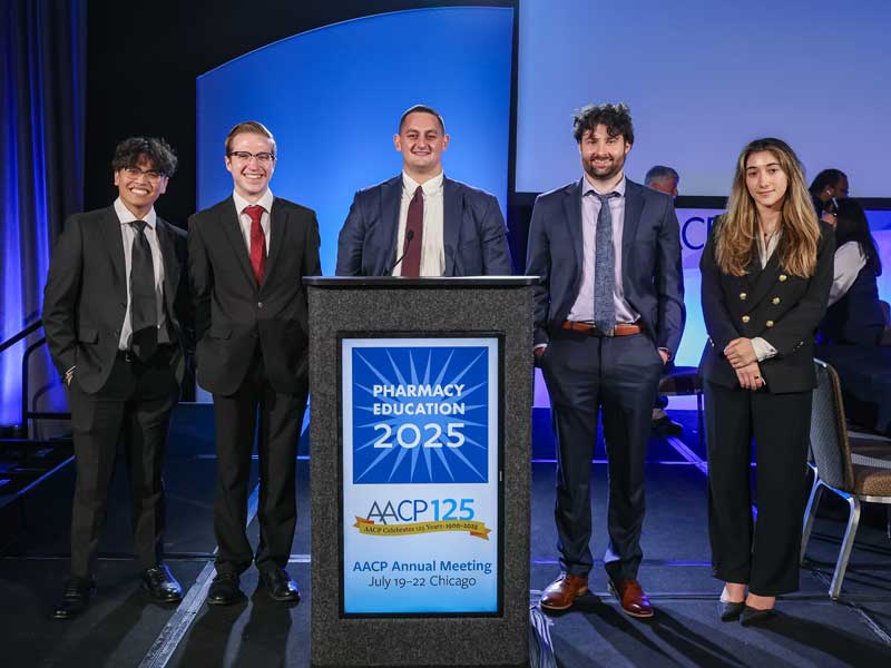 The VCU School of Pharmacy team poses on stage at the AACP 2025 Mock Trial Competition in Chicago in July 2025.